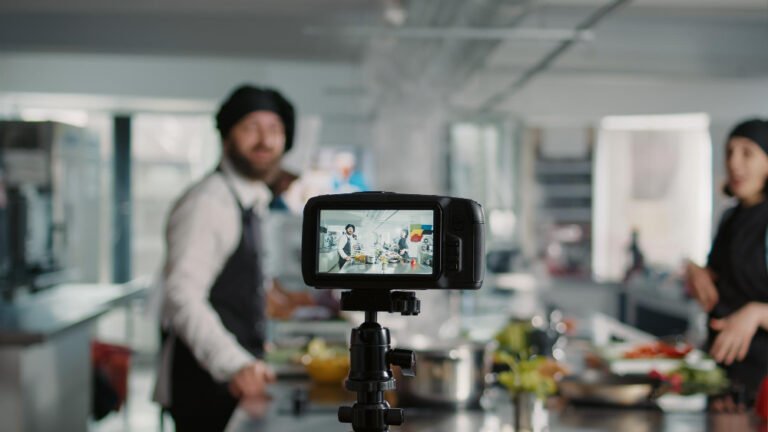 camera filming people cooking professional menu dish kitchen recording online vlog gastronomy show program tv team cooks teaching gourmet meal preparations tripod shot
